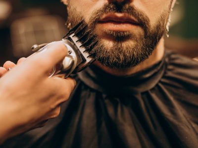 Handsome man at barbershop shaving beard